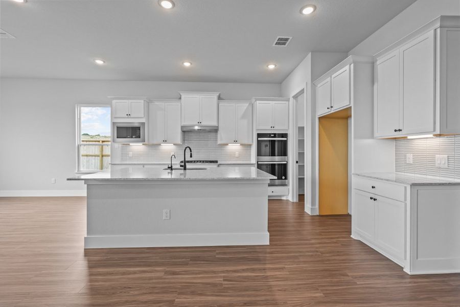 A kitchen with white cabinets. A kitchen with white cabinets.