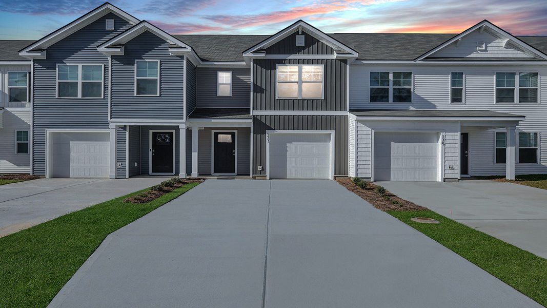 Front exterior of a new home in Pine Hills Townhomes at Cane Bay, Summerville, SC, highlighting curb appeal (Image 1).