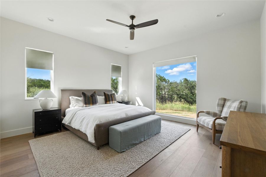 Bedroom featuring hardwood / wood-style flooring, multiple windows, a ceiling fan, and recessed lighting