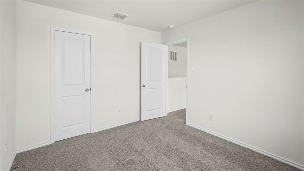 Room with light gray carpet, white walls, and white baseboards