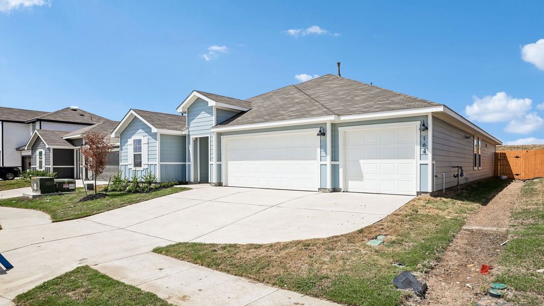 Front exterior of a new home in Prairie Lakes, Buda, TX, highlighting curb appeal (Image 23).