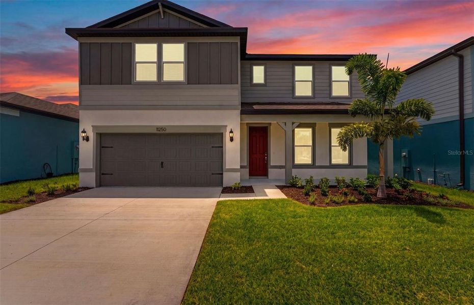 Front exterior of a new home in Evergreen, Thonotosassa, FL, highlighting curb appeal (Image 2). Front exterior of a new home in Evergreen, Thonotosassa, FL, highlighting curb appeal (Image 2).