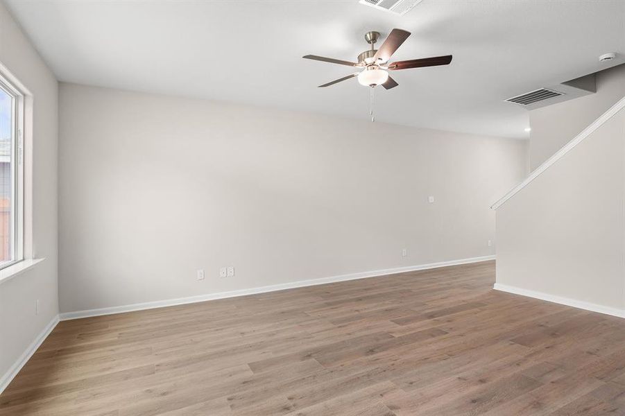 Spare room with light wood-style flooring and a ceiling fan Spare room with light wood-style flooring and a ceiling fan