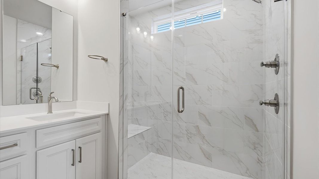 Elegant primary bathroom featuring a spacious walk-in shower in this first-class DRB Homes design Elegant primary bathroom featuring a spacious walk-in shower in this first-class DRB Homes design