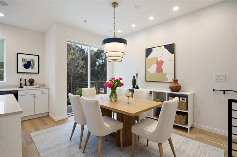 Dining room featuring light wood finished floors and recessed lighting