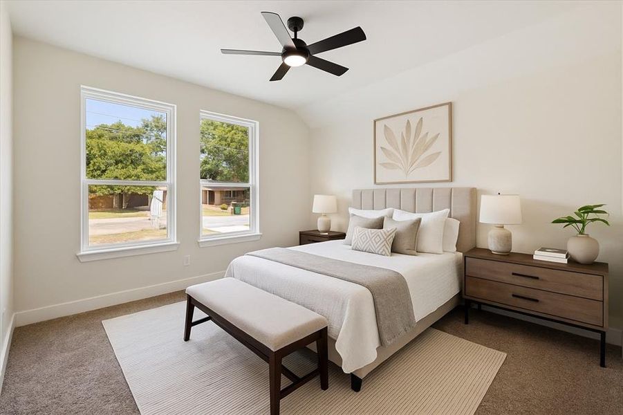 Carpeted bedroom with a ceiling fan and lofted ceiling