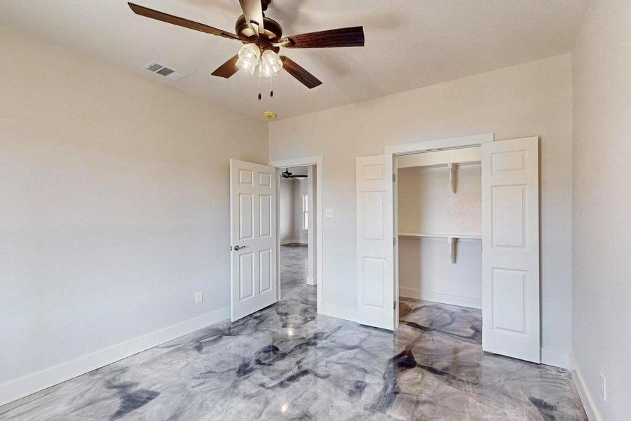 Unfurnished bedroom with a ceiling fan, a closet, visible vents, and baseboards