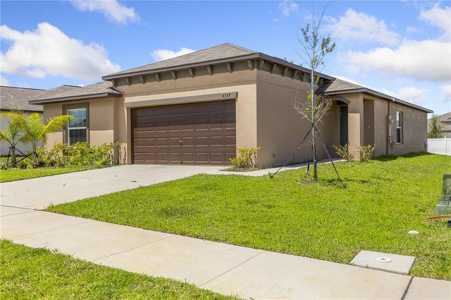 Front exterior of a new home in Wind Meadows South, Bartow, FL, highlighting curb appeal (Image 30).