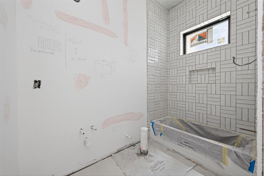 Ensuite bathroom for the fourth bedroom with three stacked basketweave shower tile