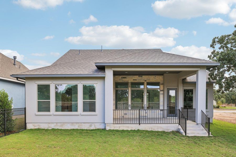 Rear view of house featuring roof with shingles, a patio, and stucco siding