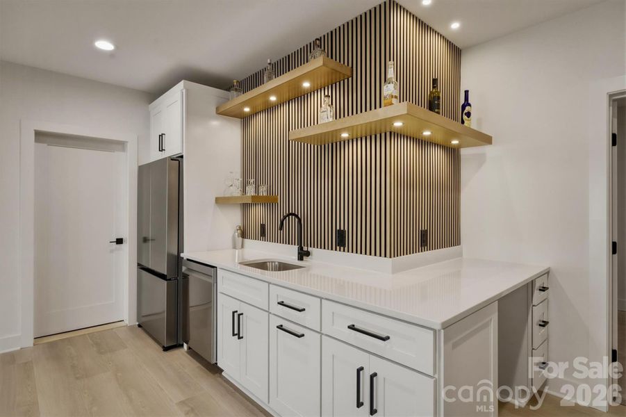 Floating shelves are there for your decorative items or bar "things". Around the corner is a flexible space. You might use it for a home office or put an undercounter appliance of your choice. Floating shelves are there for your decorative items or bar "things". Around the corner is a flexible space. You might use it for a home office or put an undercounter appliance of your choice.