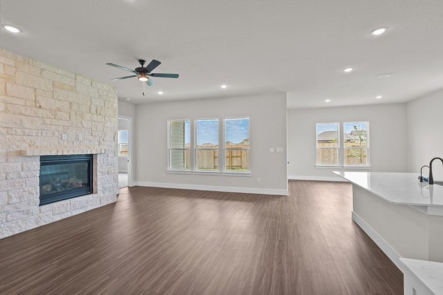 A large room with a fireplace and a wood floor. A large room with a fireplace and a wood floor.
