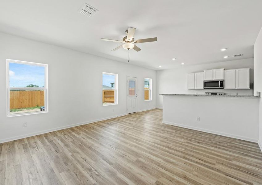 A spacious family room and adjoining kitchen and dining room