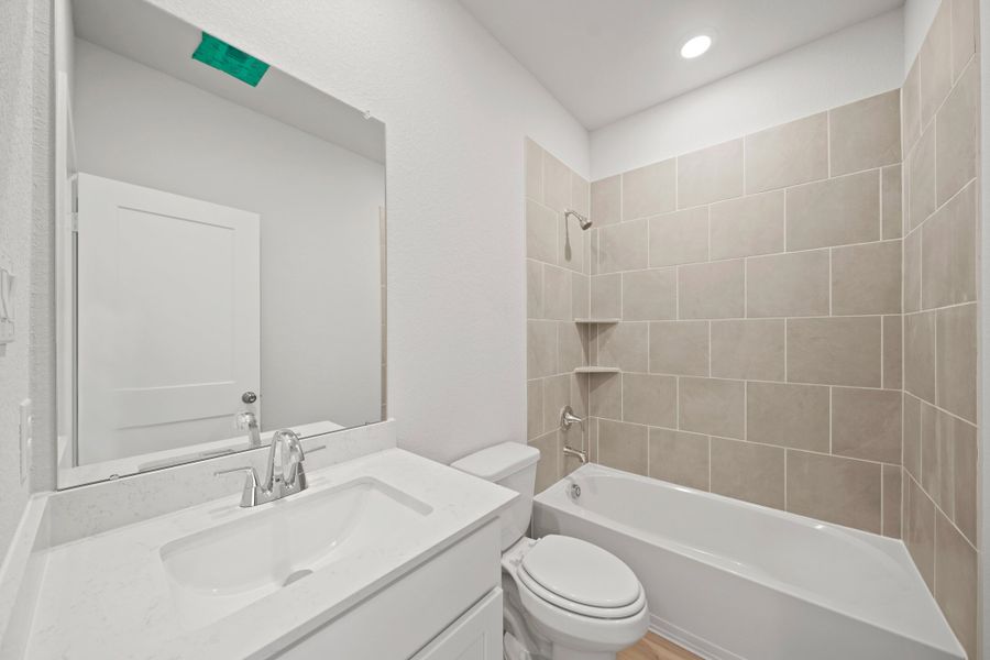 A bathroom with a sink toilet and bathtub.