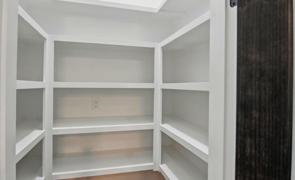 This walk-in pantry offers abundant shelving and storage space, perfect for keeping your kitchen essentials neat and accessible. The built-in shelves provide plenty of room for dry goods, small appliances, and extra cookware, while the bright white finish enhances the clean, modern look. Thoughtfully designed for both function and style, this pantry is an ideal extension of the home’s gourmet kitchen. This walk-in pantry offers abundant shelving and storage space, perfect for keeping your kitchen essentials neat and accessible. The built-in shelves provide plenty of room for dry goods, small appliances, and extra cookware, while the bright white finish enhances the clean, modern look. Thoughtfully designed for both function and style, this pantry is an ideal extension of the home’s gourmet kitchen.