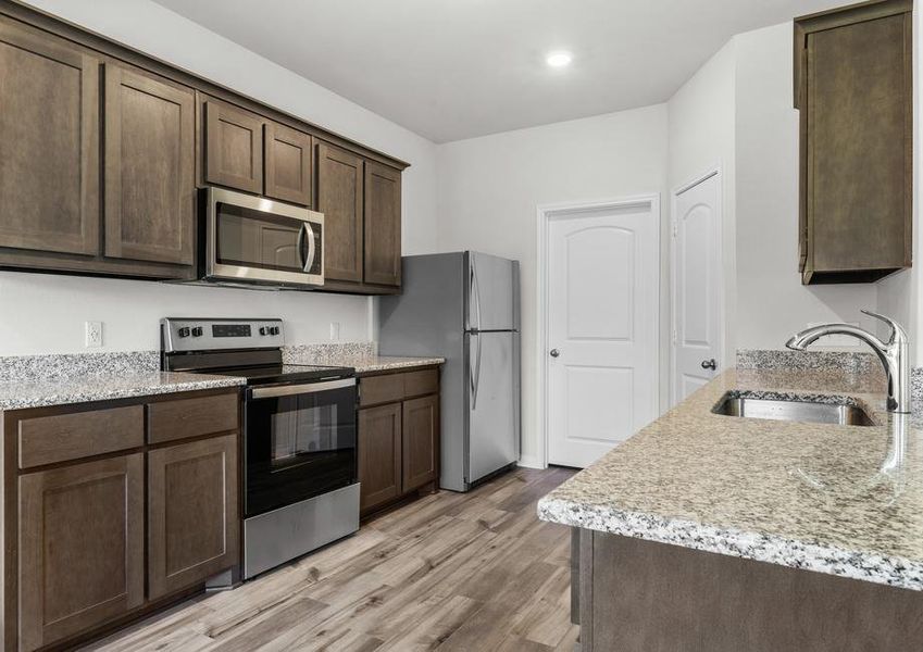 The kitchen of the Cypress has gorgeous wood cabinetry.