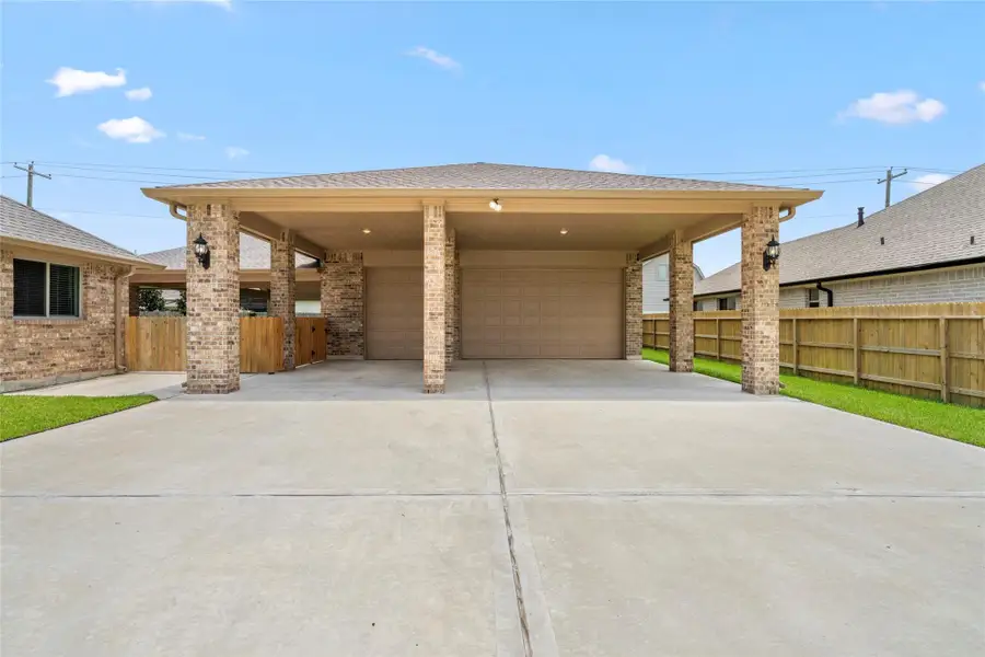 The expansive driveway leads to a massive covered porte cochere offering abundant parking and storage beyond the attached garage, a rare and highly coveted feature perfect for boats, RVs, or additional vehicles. The expansive driveway leads to a massive covered porte cochere offering abundant parking and storage beyond the attached garage, a rare and highly coveted feature perfect for boats, RVs, or additional vehicles.
