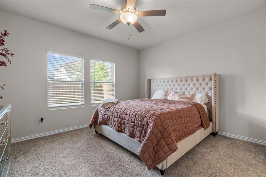 Bedroom with light carpet and ceiling fan Bedroom with light carpet and ceiling fan