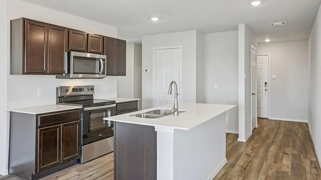 Culinary delights await in this modern kitchen with stainless steel appliances and an inviting island. Culinary delights await in this modern kitchen with stainless steel appliances and an inviting island.