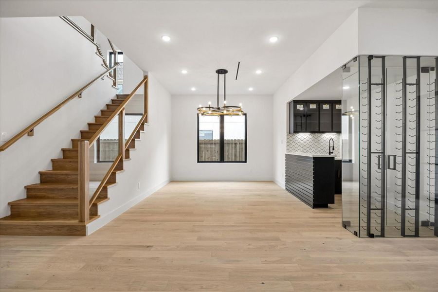 The formal Dining is served by the adjacent wet bar which is defined by a glass wall from the entry area.