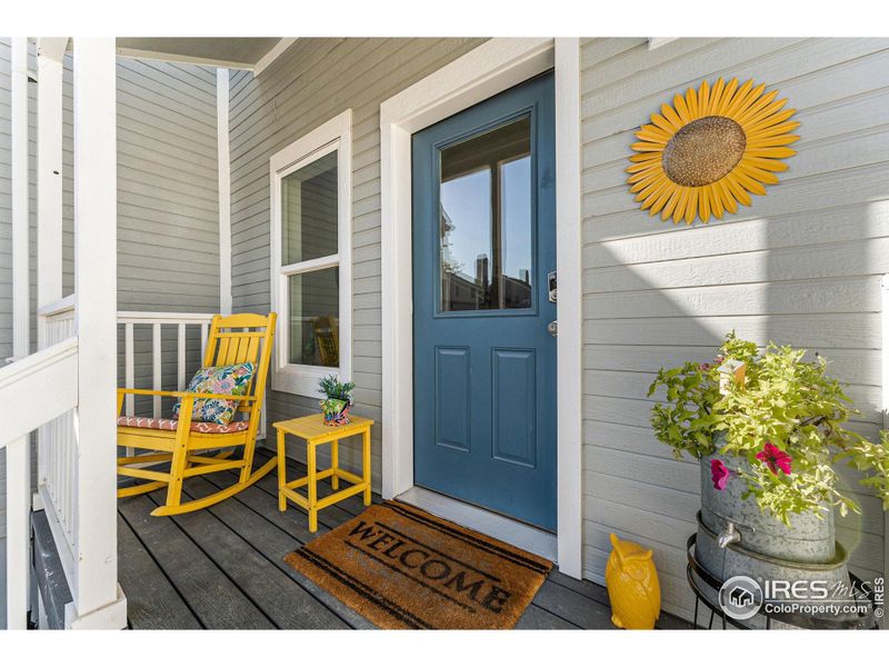 This welcoming front porch overlooks the neighborhood greenspace.