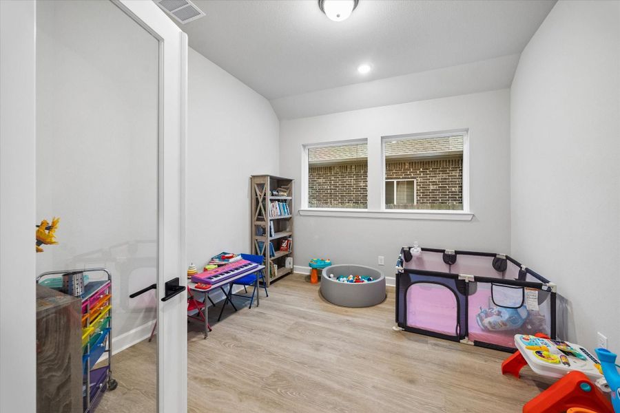 Spacious home office featuring luxury vinyl plank flooring, neutral tones, and abundant natural light. Spacious home office featuring luxury vinyl plank flooring, neutral tones, and abundant natural light.