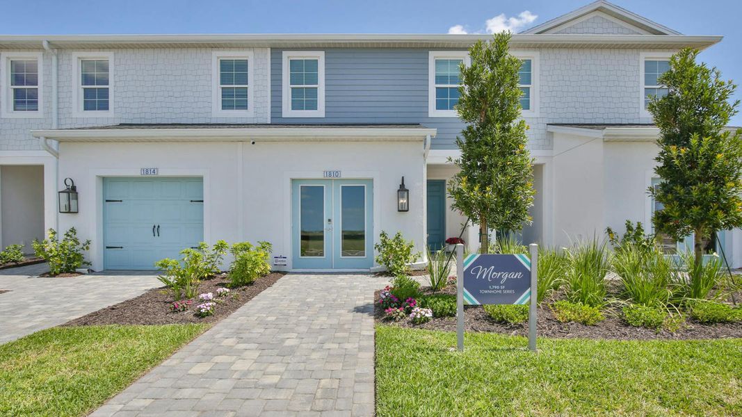 Front exterior of a new home in Palm Grove Real Estate and Homes for Sale in Lakewood Ranch, FL - Neal Communities, Lakewood Ranch, FL, highlighting curb appeal (Image 2).