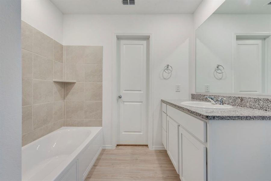 Bathroom with vanity and wood-type flooring