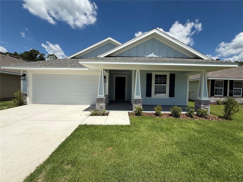 Front exterior of a new home in Savannah Station, Alachua, FL, highlighting curb appeal (Image 26).