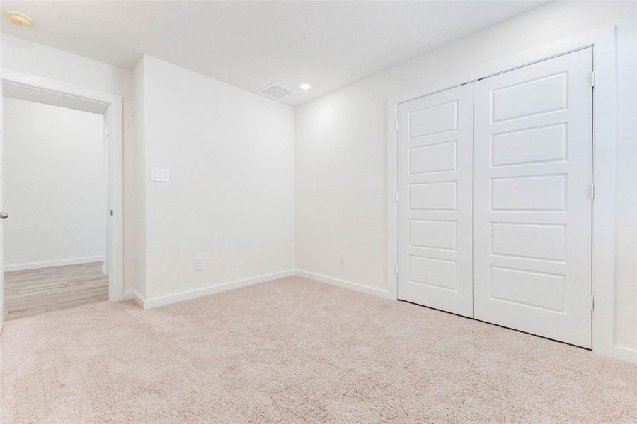 Bright and inviting, this additional bedroom is a perfect fit for family, guests, or your own creative use. Double-door closet space, modern recessed lighting, and soft carpeting provide the ideal mix of practicality and comfort. Bright and inviting, this additional bedroom is a perfect fit for family, guests, or your own creative use. Double-door closet space, modern recessed lighting, and soft carpeting provide the ideal mix of practicality and comfort.