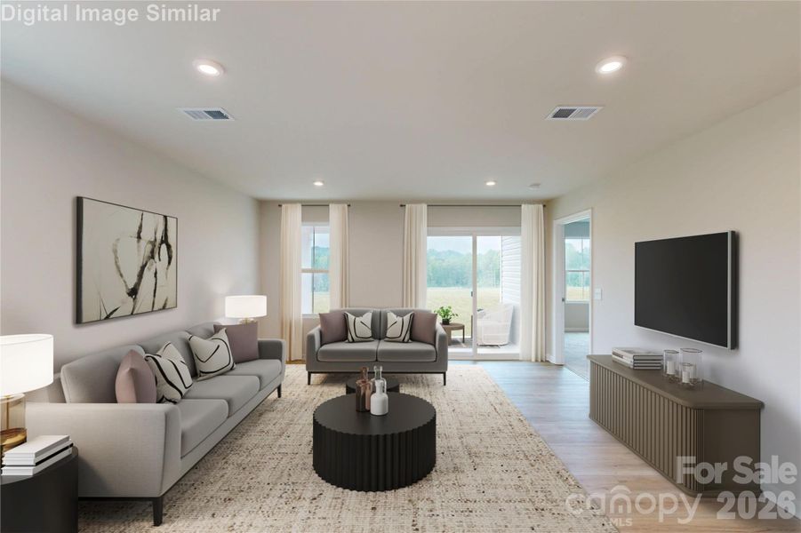 Spacious open floor plan featuring a sunlight great room with large window and sliding door that flood the space with natural light.