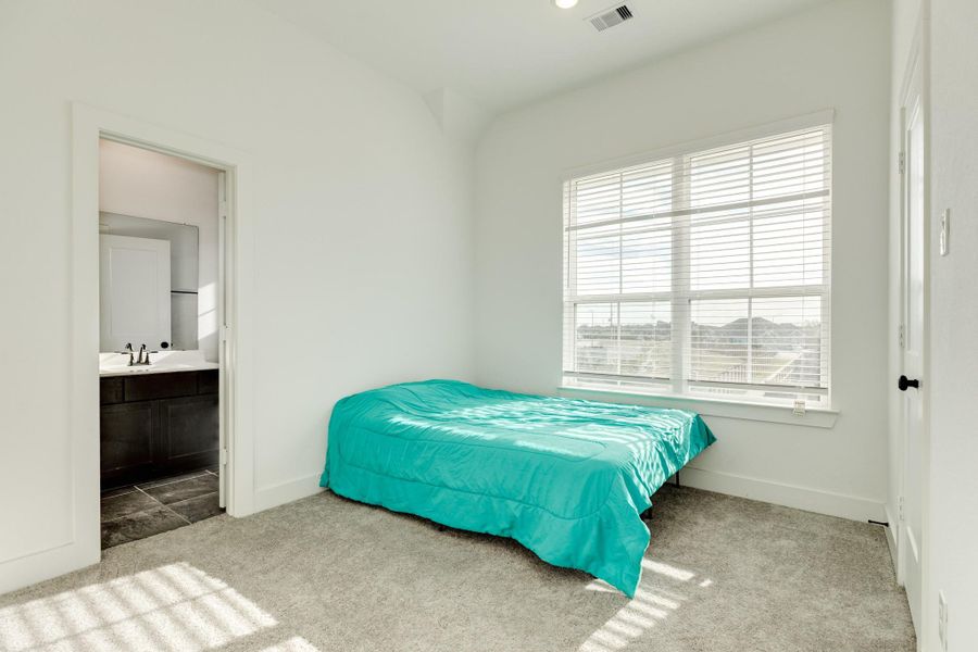 Secondary bedroom adjacent to the jack and jill bath, shared with the other secondary bedroom, facing the street.