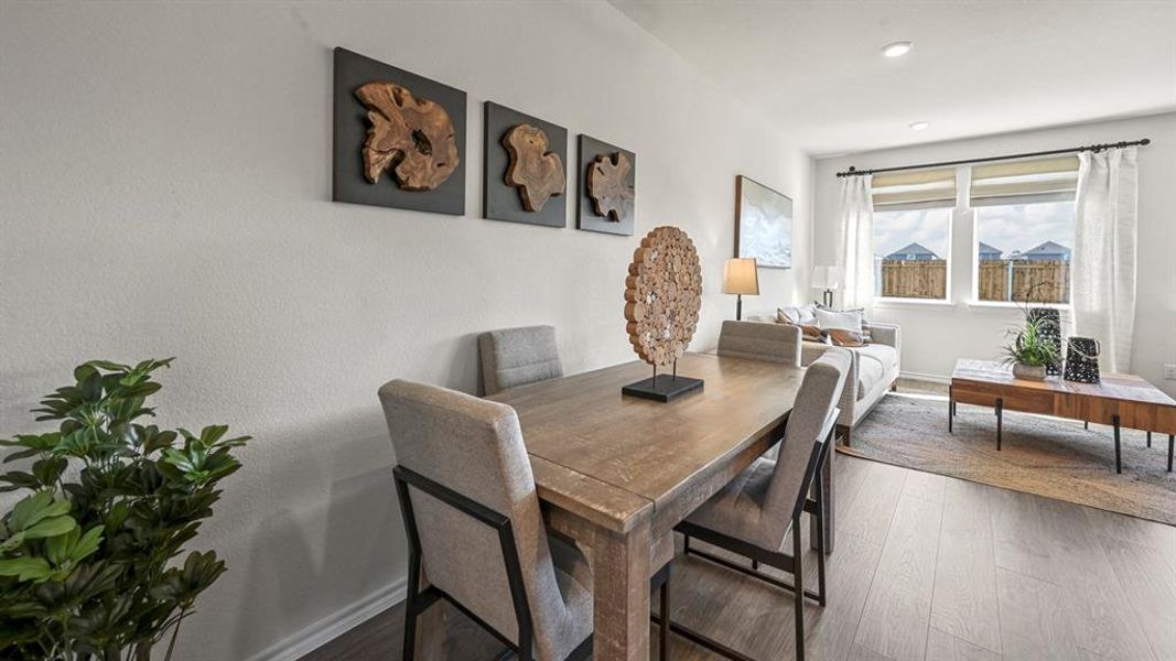 Dining space featuring dark wood-type flooring and recessed lighting
