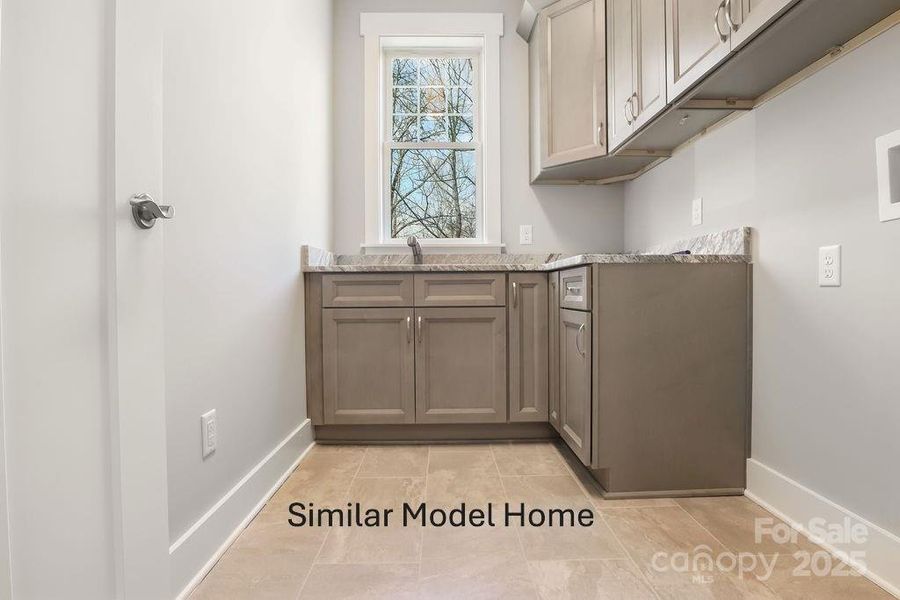 Laundry room with lots of cabinet storage and utility sink Laundry room with lots of cabinet storage and utility sink