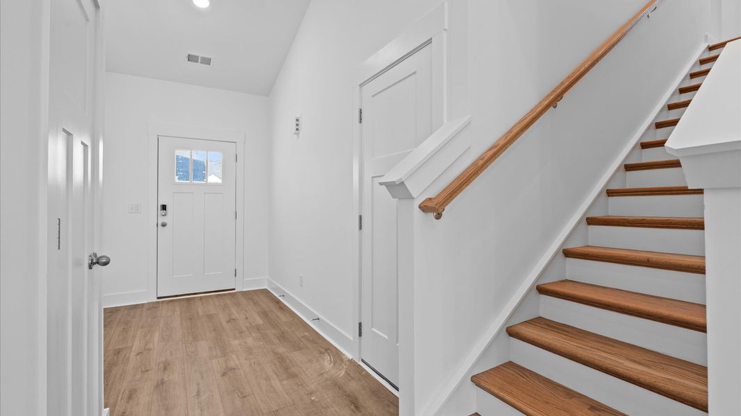 Notable hardwood flooring enhances the elegance of this accomplished entryway