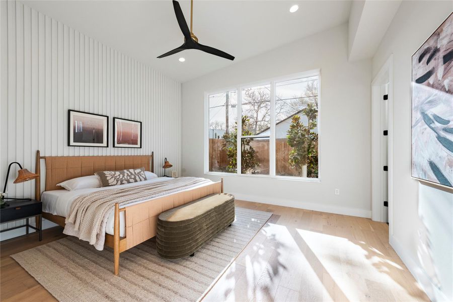 Bedroom featuring a ceiling fan, recessed lighting, baseboards, and wood finished floors