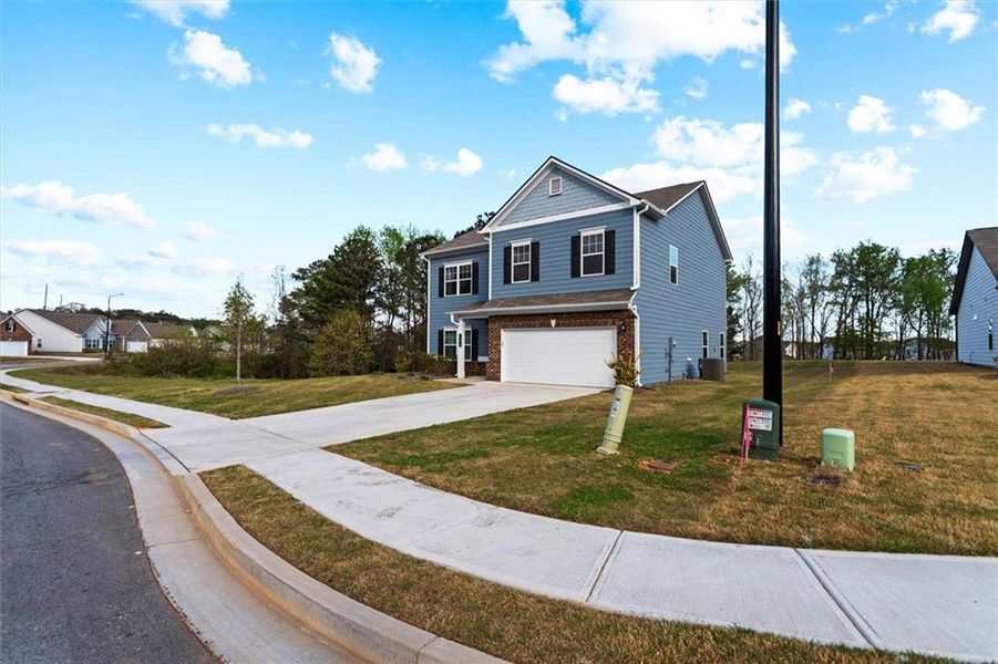Front exterior of a new home in Garrett Preserve, Hiram, GA, highlighting curb appeal (Image 30).