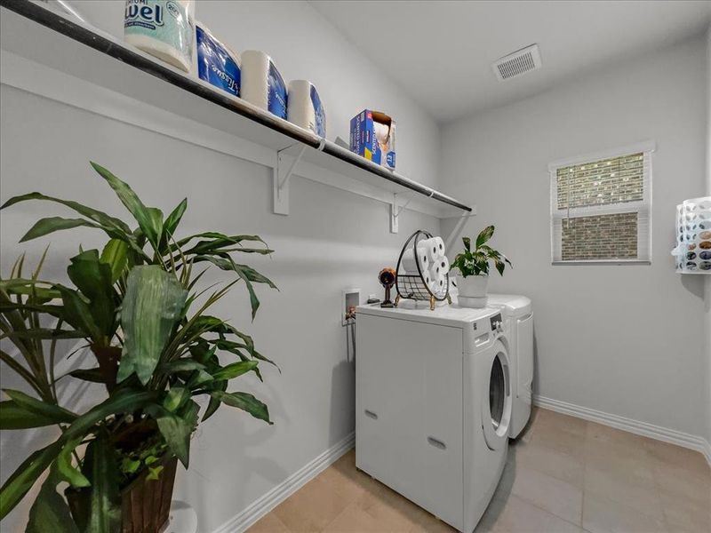 Clothes washing area featuring separate washer and dryer