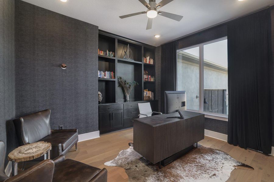 A private office provides a quiet, functional workspace with stylish finishes.