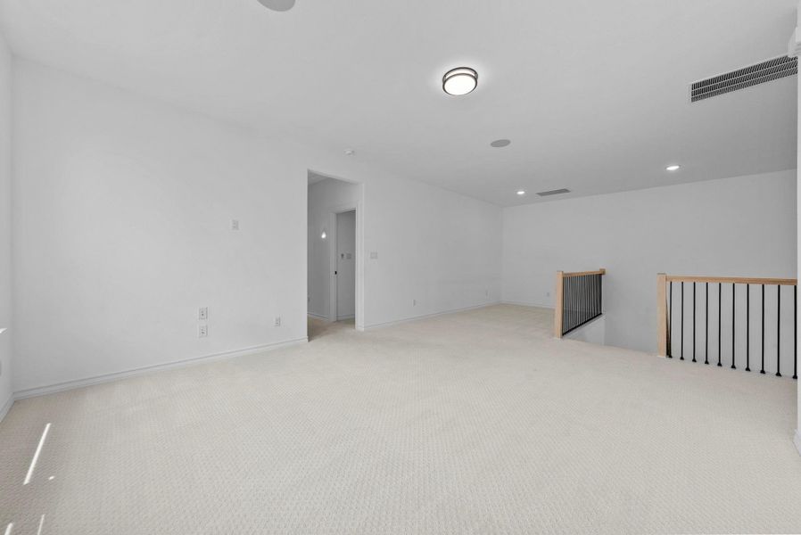 Large upstairs bonus room offering flexible space for entertainment, work, or play.