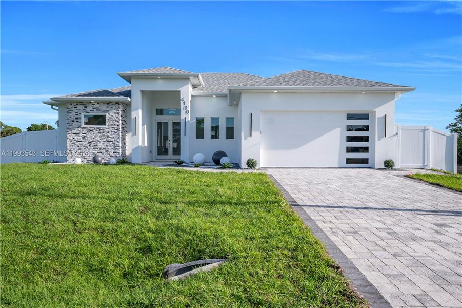 Front exterior of a new home in , Lehigh Acres, FL, highlighting curb appeal (Image 22).