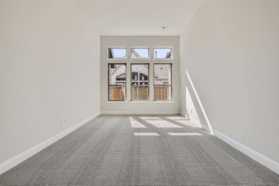 Empty room featuring light carpet