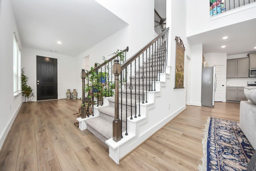 Stylish staircase and welcoming foyer with contemporary finishes.
