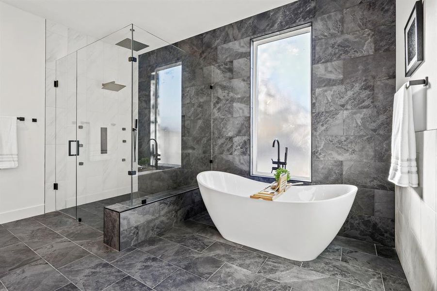 Bathroom featuring plus walk in shower and tile walls