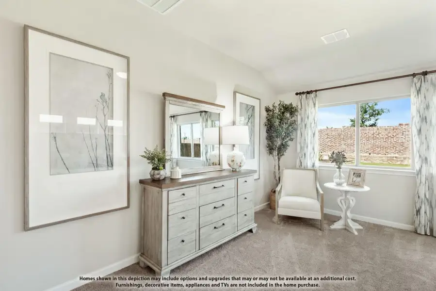 Bedroom with gray dresser, mirror, vaulted ceiling, carpet flooring, and large window with patterned curtains