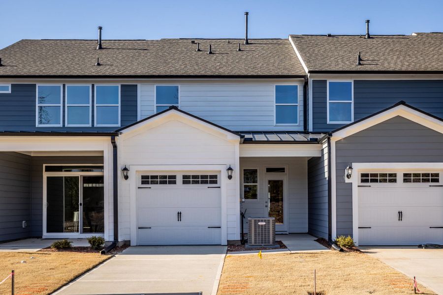 Front exterior of a new home in Enclave at Traditions Townhomes, Wake Forest, NC, highlighting curb appeal (Image 5). Front exterior of a new home in Enclave at Traditions Townhomes, Wake Forest, NC, highlighting curb appeal (Image 5).