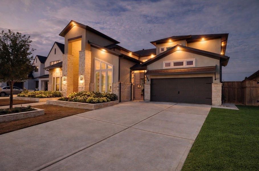 A spacious driveway and three-car garage offer a grand welcome home.