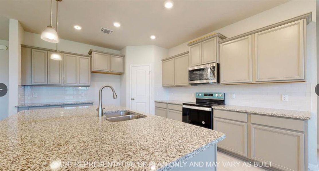 Kitchen featuring light stone counters, appliances with stainless steel finishes, backsplash, a sink, and visible vents Kitchen featuring light stone counters, appliances with stainless steel finishes, backsplash, a sink, and visible vents
