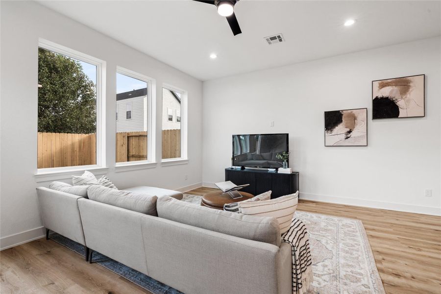 Framed by expansive windows,the living area feels airy andconnected, designed tomaximize both sunlight and spatial flow.