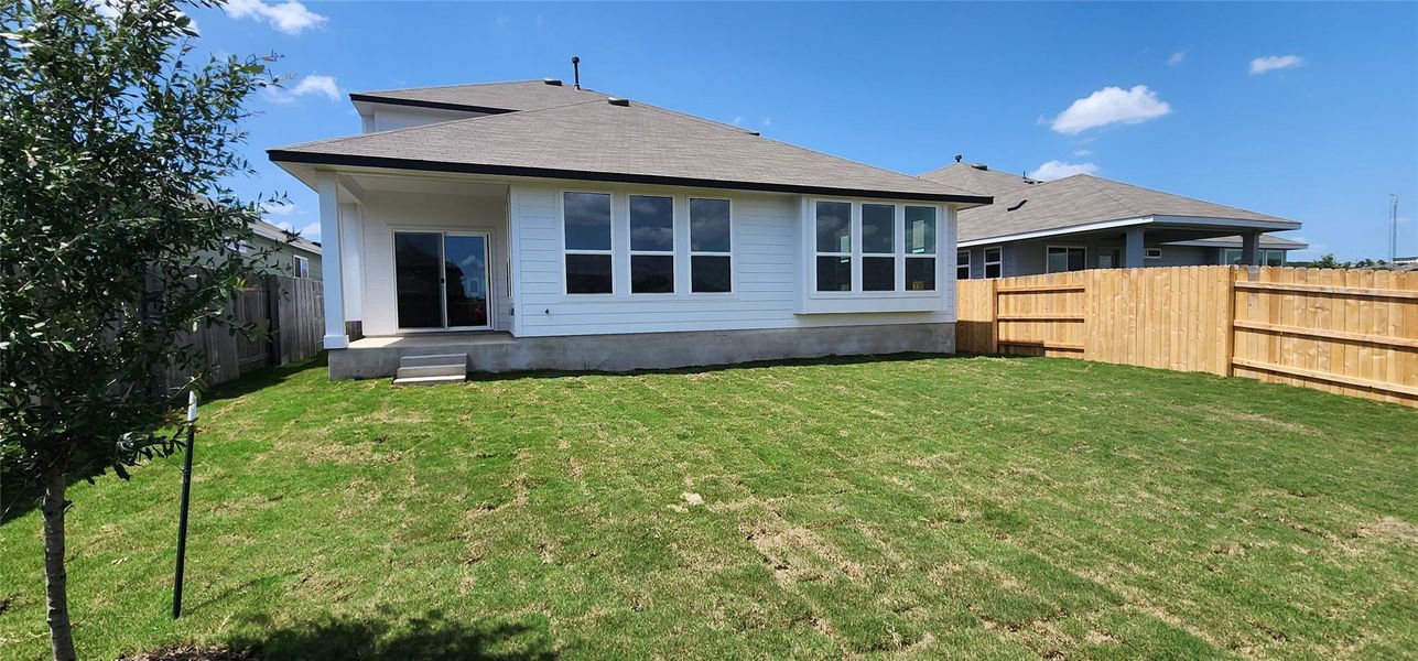 Back of property with a fenced backyard and a shingled roof Back of property with a fenced backyard and a shingled roof